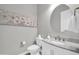 Modern powder room with marble vanity and artwork at 17531 W Liberty Ln, Goodyear, AZ 85338