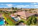 Beautiful aerial view showcasing a sparkling pool, lush landscaping, and outdoor seating spaces at 1783 E Desert Broom Pl, Chandler, AZ 85286