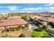 An aerial view shows the large backyard with a pool, an outdoor dining area, and an expansive green lawn at 1783 E Desert Broom Pl, Chandler, AZ 85286