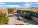 A beautiful backyard featuring a pool with a waterfall, a dining area and plenty of patio space at 1783 E Desert Broom Pl, Chandler, AZ 85286