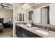 Bathroom with double sinks, granite countertops, and white cabinets providing ample storage space at 1783 E Desert Broom Pl, Chandler, AZ 85286