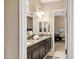 Bathroom with double sinks, granite countertops, and white cabinets providing ample storage space at 1783 E Desert Broom Pl, Chandler, AZ 85286