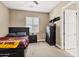 Cozy bedroom with a dark wood bed frame and a large dresser for storage and comfort at 1783 E Desert Broom Pl, Chandler, AZ 85286
