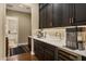 Coffee bar area with dark wood cabinets, white counters, and stainless steel appliances at 1783 E Desert Broom Pl, Chandler, AZ 85286