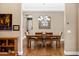 Dining room featuring a modern chandelier, wooden table and chairs, and a decorative mirror at 1783 E Desert Broom Pl, Chandler, AZ 85286