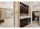 Hallway area with custom cabinetry, a beverage cooler, and access to a walk-in closet at 1783 E Desert Broom Pl, Chandler, AZ 85286