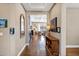 Hallway with hardwood floors leading to a living area, complemented by a wood console table at 1783 E Desert Broom Pl, Chandler, AZ 85286