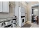 Efficient laundry room with storage cabinets, washer, dryer, and shelving at 1783 E Desert Broom Pl, Chandler, AZ 85286