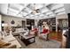 Open-concept living room with coffered ceilings, hardwood floors, and seamless flow to the kitchen at 1783 E Desert Broom Pl, Chandler, AZ 85286
