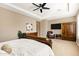 Spacious main bedroom featuring a ceiling fan, wall-mounted TV, and a sitting area at 1783 E Desert Broom Pl, Chandler, AZ 85286