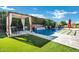 A backyard oasis featuring a pergola, beautiful pool with a waterfall, and well-manicured landscaping at 1783 E Desert Broom Pl, Chandler, AZ 85286