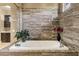 A large soaking tub with decorative tile backsplash and views of the beautiful shower area at 1783 E Desert Broom Pl, Chandler, AZ 85286