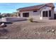 The backyard has desert landscaping with a rock bed and pergola covered patio at 20301 N Queen Palm Ln, Surprise, AZ 85374