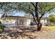 Backyard with patio, gravel, and mature tree at 2037 E Fountain St, Mesa, AZ 85213