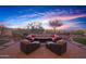 Spacious backyard with a fire pit and seating area at 20606 W Daniel Pl, Buckeye, AZ 85396