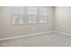 Well-lit bedroom with neutral walls and carpet flooring at 2320 W Moody Trl, Phoenix, AZ 85041