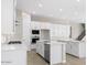 Modern kitchen with white cabinets, quartz countertops, and a large island at 2320 W Moody Trl, Phoenix, AZ 85041