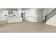 Open concept kitchen with white cabinets, island, and hardwood floors at 2320 W Moody Trl, Phoenix, AZ 85041