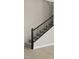 Modern staircase with black metal railings and gray carpeting at 2320 W Moody Trl, Phoenix, AZ 85041