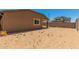 Spacious backyard with sand and sparse vegetation at 25838 W Samantha Way, Buckeye, AZ 85326