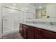 Modern bathroom with dark brown vanity, granite countertop, and shower at 25838 W Samantha Way, Buckeye, AZ 85326