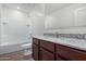Clean bathroom with a bathtub, shower, and granite countertop at 25838 W Samantha Way, Buckeye, AZ 85326