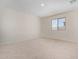 Bright bedroom featuring a large window and plush carpeting at 25838 W Samantha Way, Buckeye, AZ 85326