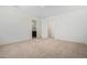 Spacious bedroom with neutral carpeting and access to a bathroom at 25838 W Samantha Way, Buckeye, AZ 85326
