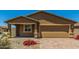 Charming new construction home with a two-car garage and nicely landscaped yard at 25838 W Samantha Way, Buckeye, AZ 85326