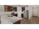 Modern kitchen with dark cabinets, granite counters, and stainless steel appliances at 25838 W Samantha Way, Buckeye, AZ 85326