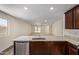Modern kitchen with an island, granite countertops, and stainless steel appliances at 25838 W Samantha Way, Buckeye, AZ 85326