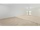 Bright and airy living room featuring carpet and sliding glass doors at 25838 W Samantha Way, Buckeye, AZ 85326