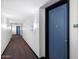 Hallway view with a blue door and black trim, leading to additional units with visible exit signs at 310 S 4Th St # 908, Phoenix, AZ 85004