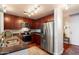 Galley kitchen featuring stainless steel appliances, granite counters, dark wood cabinets, and hardwood floors at 310 S 4Th St # 908, Phoenix, AZ 85004