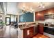 Stylish kitchen with stainless steel appliances, dark wood cabinets, granite counters, and hardwood floors, opening to living space at 310 S 4Th St # 908, Phoenix, AZ 85004