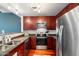 Kitchen featuring stainless steel appliances, granite counters, dark wood cabinets, and hardwood floors at 310 S 4Th St # 908, Phoenix, AZ 85004