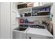 Well-organized laundry area with washer, dryer, and ample shelving for storage at 310 S 4Th St # 908, Phoenix, AZ 85004