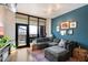 Comfortable living room with a gray sectional, hardwood floors, and a view of the city skyline through large windows at 310 S 4Th St # 908, Phoenix, AZ 85004