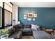 Comfortable living room with a large sectional sofa, accent wall, and bright natural light from the large window at 310 S 4Th St # 908, Phoenix, AZ 85004