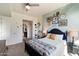Bright bedroom with a queen bed, a bookshelf, and a view into the bathroom at 310 S 4Th St # 908, Phoenix, AZ 85004