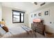 Comfortable bedroom with a queen bed, window, dresser with a TV and simple but stylish decor at 310 S 4Th St # 908, Phoenix, AZ 85004