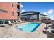 Rooftop pool with lounge chairs, umbrellas, and stadium views at 310 S 4Th St # 908, Phoenix, AZ 85004
