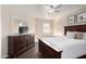 Bedroom with dark wood dresser and ceiling fan at 3218 E Briarwood Ter, Phoenix, AZ 85048