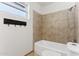 Bathroom with tiled shower and bathtub at 3312 E Flower St, Phoenix, AZ 85018