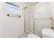 Clean bathroom with white tile shower and gold fixtures at 3312 E Flower St, Phoenix, AZ 85018