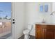 Small bathroom with toilet, sink, and granite countertop at 3312 E Flower St, Phoenix, AZ 85018