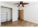 Bedroom with wood floors, built-in shelving, and ceiling fan at 3312 E Flower St, Phoenix, AZ 85018