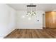 Dining room with hardwood floors and unique light fixture at 3312 E Flower St, Phoenix, AZ 85018