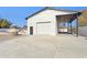 Detached garage with roll-up door and covered patio area at 3312 E Flower St, Phoenix, AZ 85018