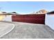 Modern, red metal gate leading to the property at 3312 E Flower St, Phoenix, AZ 85018